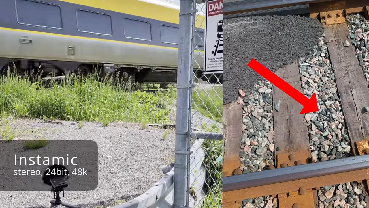 Train passing behind fence with red arrow pointing to recorder mounted near the track