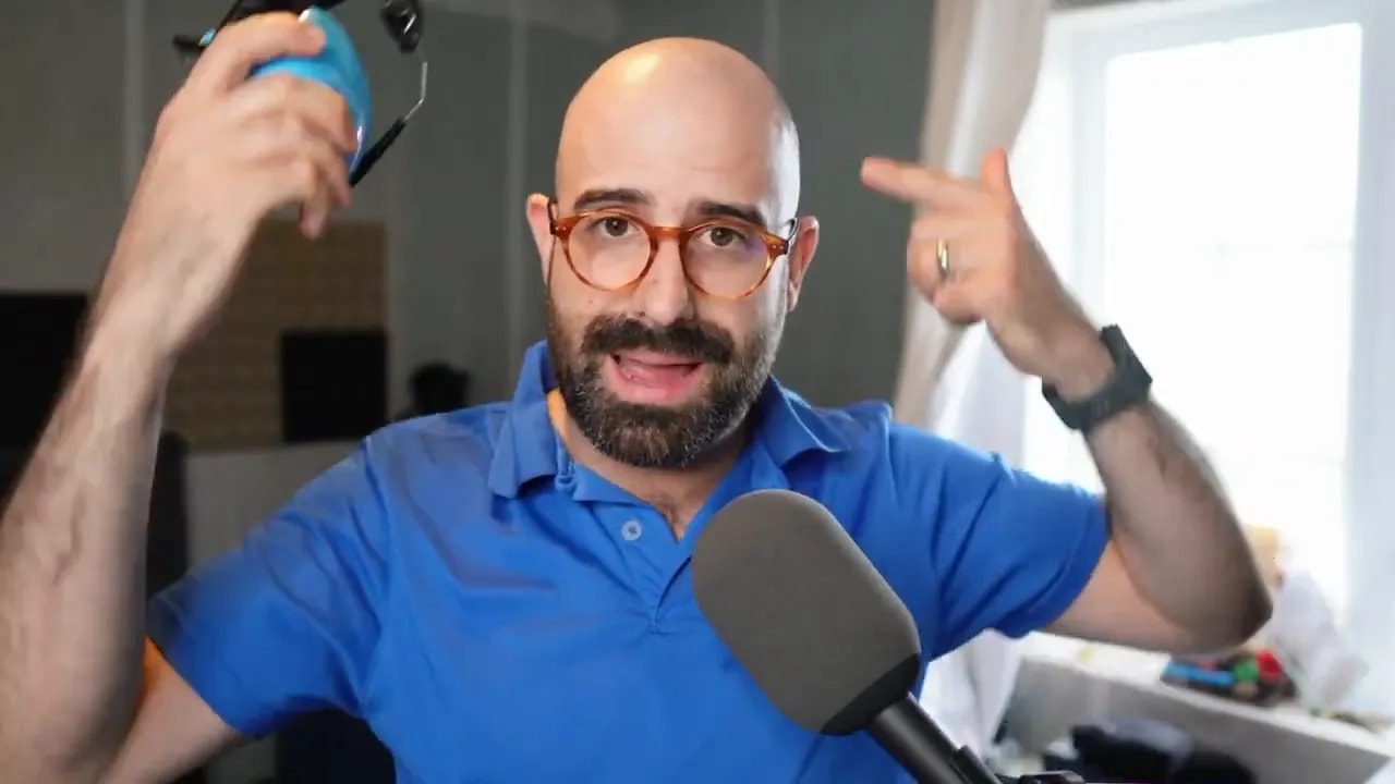 Blue and black earmuffs held beside a microphone